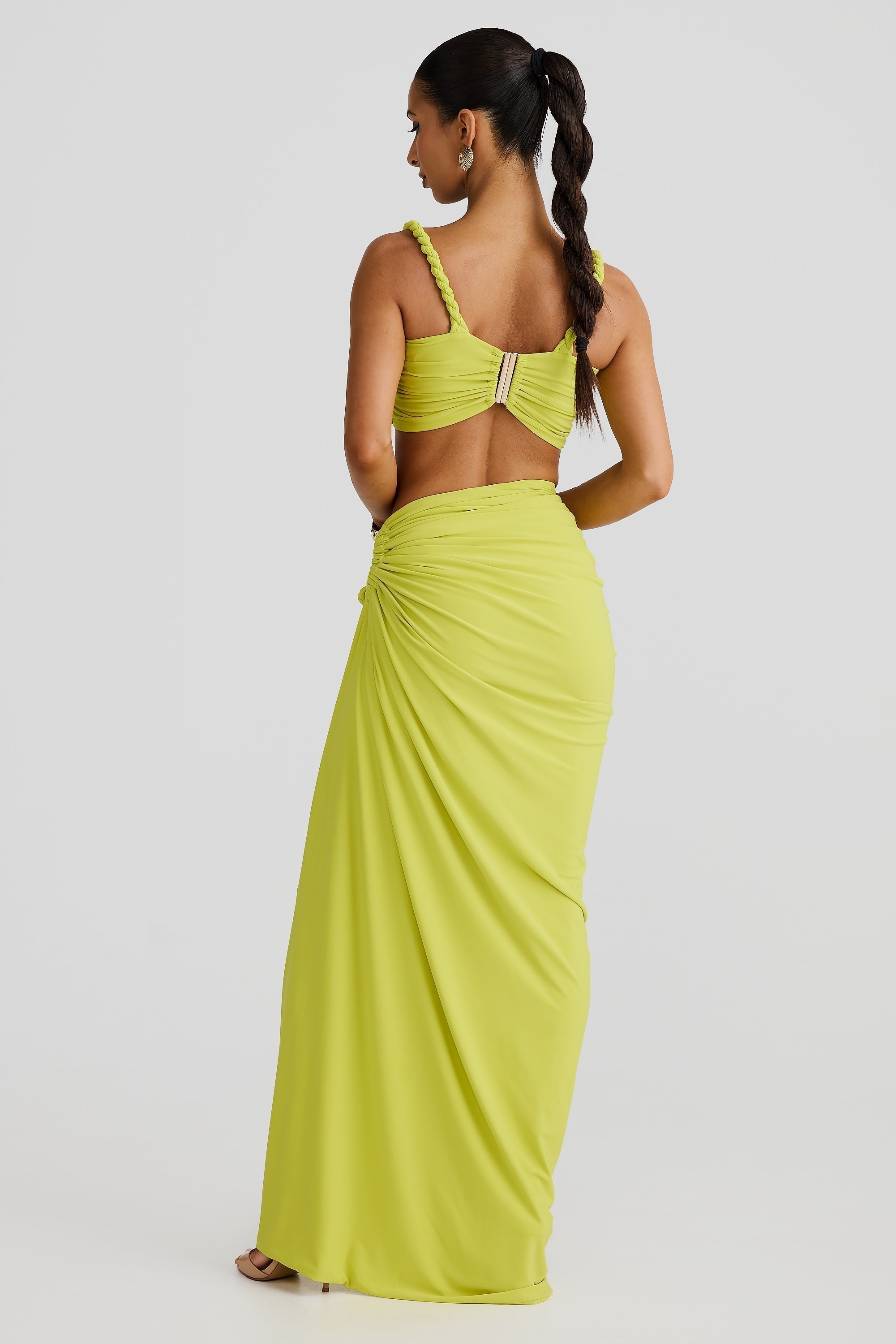 Back view of lime green Sophie Braided Maxi Set, featuring a ruched crop top with braided straps and a draped maxi skirt.