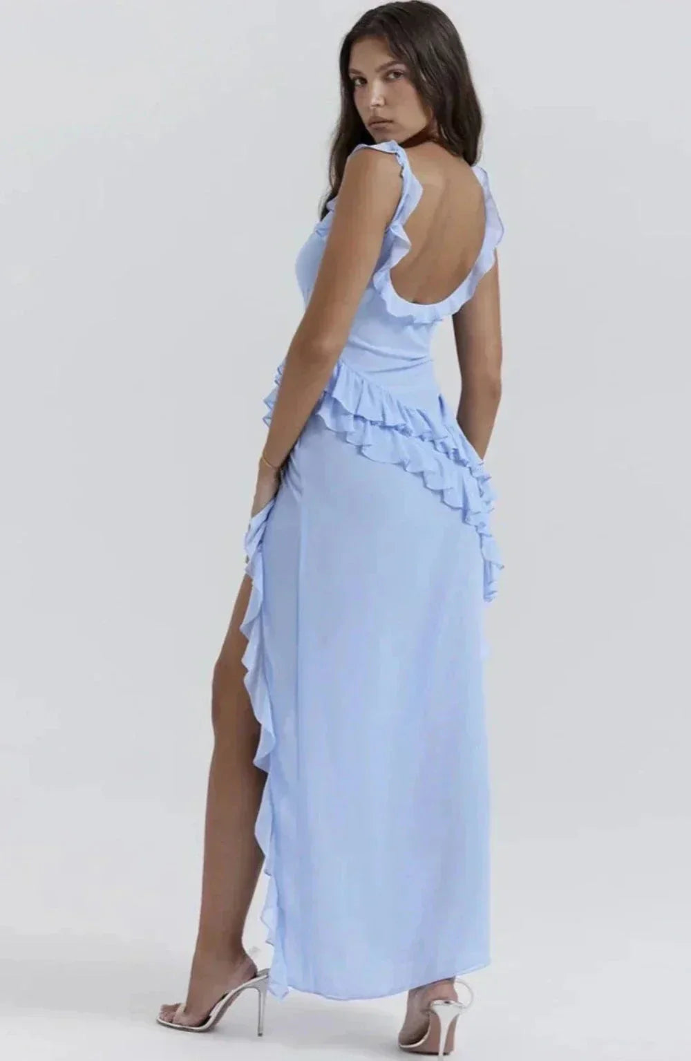Back view of light blue Sylvia Ruffle Maxi Dress with open back, ruffled shoulder straps, and cascading side ruffles.