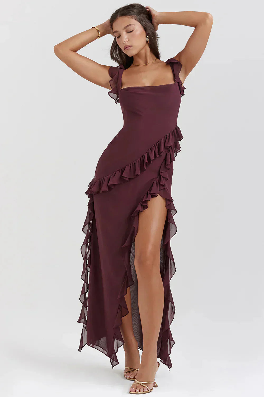 Full length view of the burgundy Sylvia Ruffle Maxi Dress with ruffled straps and a high ruffled slit.
