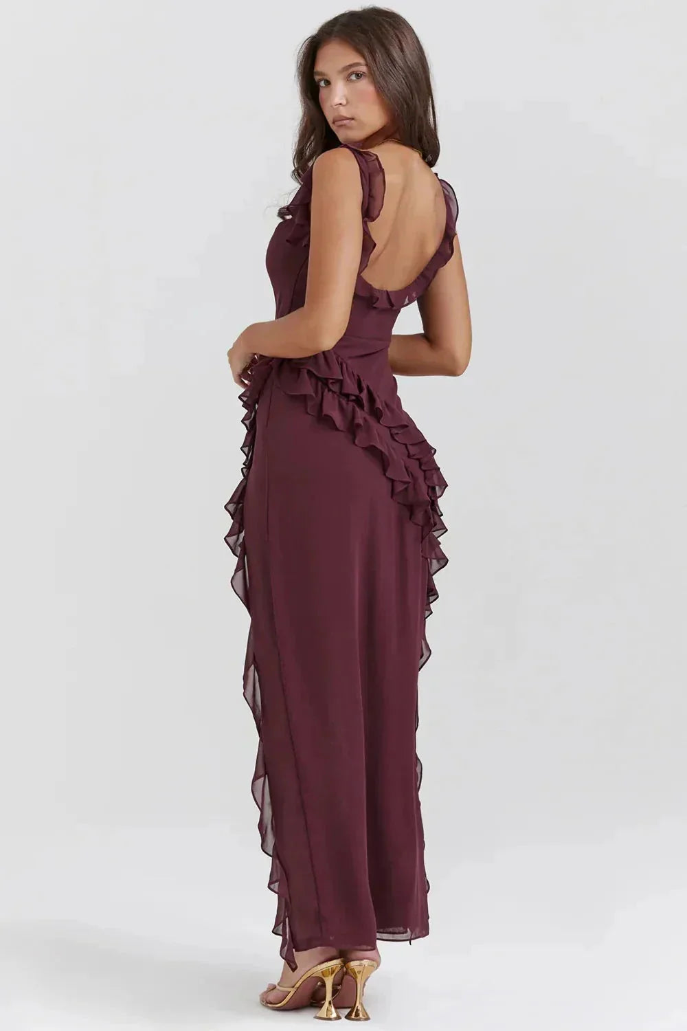 Back view of the burgundy Sylvia Ruffle Maxi Dress, showing the low back and cascading ruffles along the skirt.