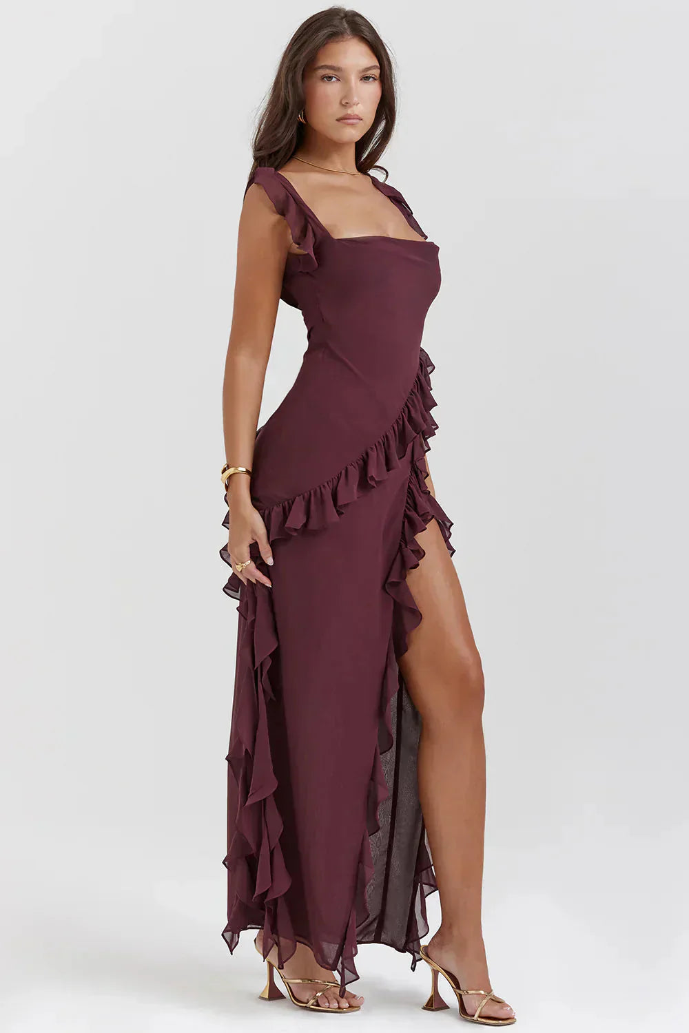 Burgundy Sylvia Ruffle Maxi Dress with square neckline, ruffled straps, and a high slit with cascading ruffles.