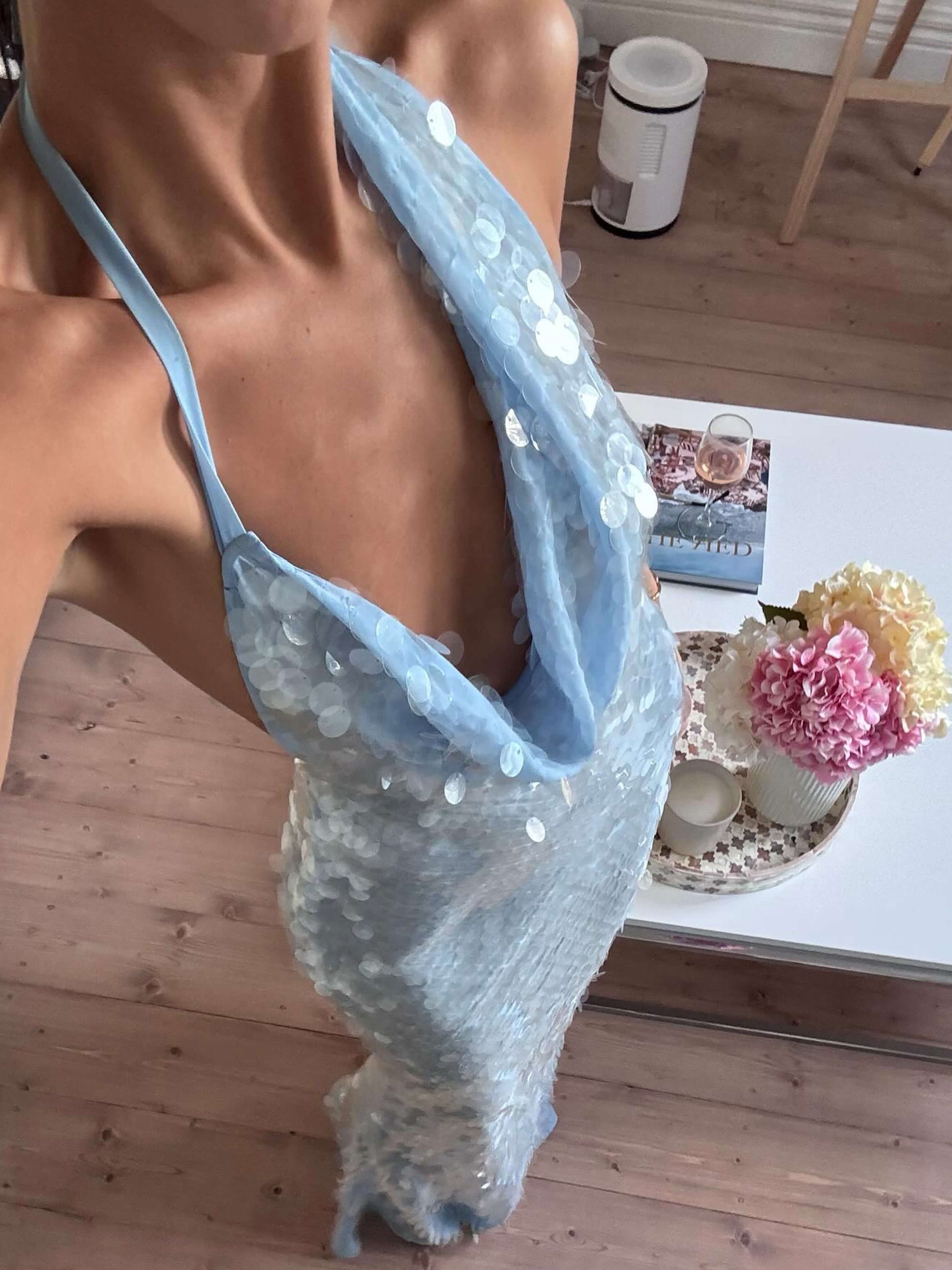 Close-up of the light blue sequin halter maxi dress, highlighting the intricate sequin work and cowl neck detail.