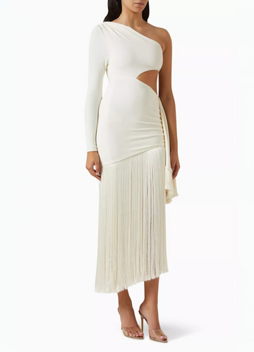 Elegant white one-shoulder maxi dress with a side cutout, long sleeve, and flowing fringe skirt detail.
