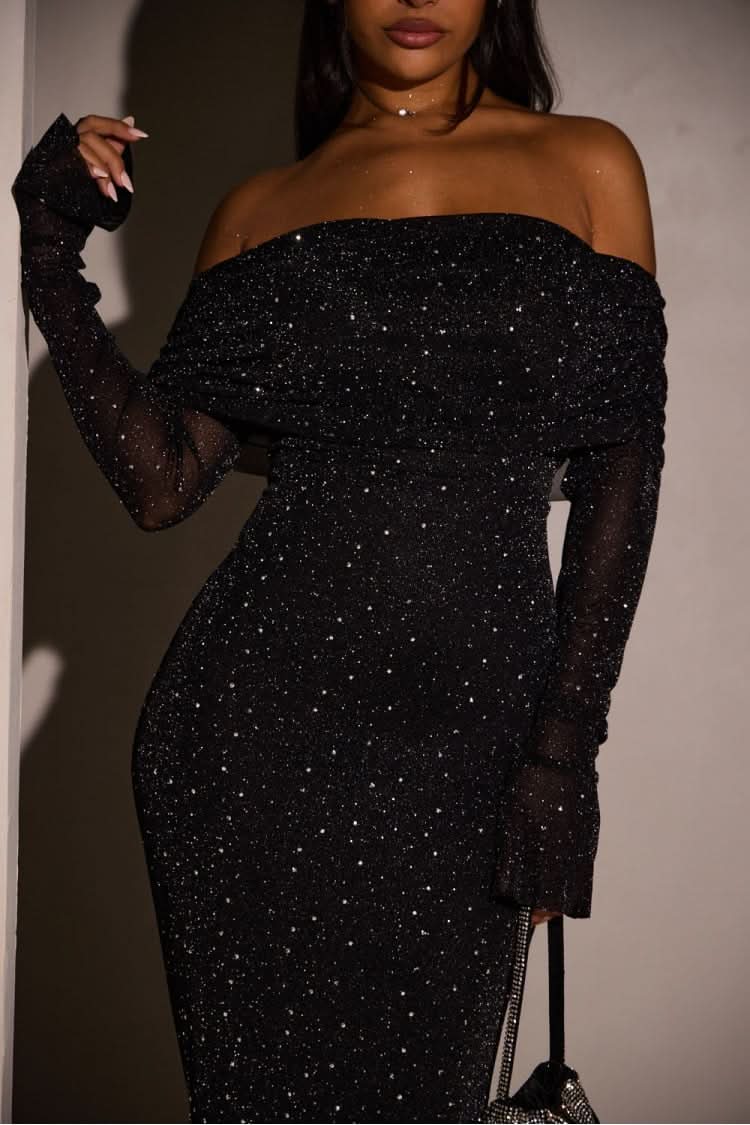 Close-up of the black glitter maxi dress, showcasing the off-the-shoulder ruched bodice and sheer long sleeves with flared cuffs.