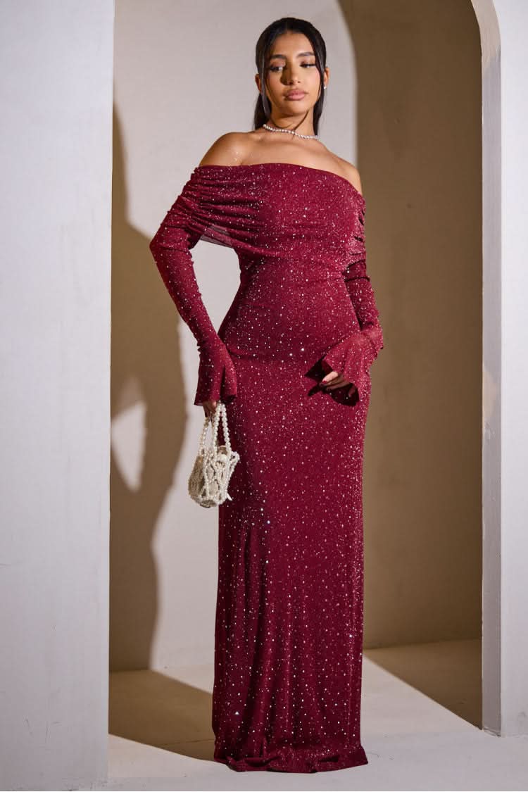 Front view of the red glitter maxi dress, showcasing the full length and the sophisticated off-the-shoulder design.