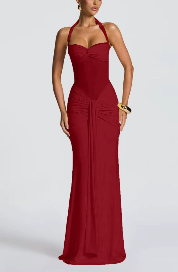 Deep red Victoria ruched maxi dress with a fitted bodice and flowing skirt, showcasing a subtle gold cuff accessory.