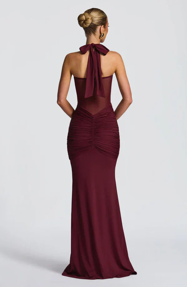 Back view of the burgundy Victoria ruched maxi dress, showing the tie-neck detail and gathered ruching on the back of the skirt.