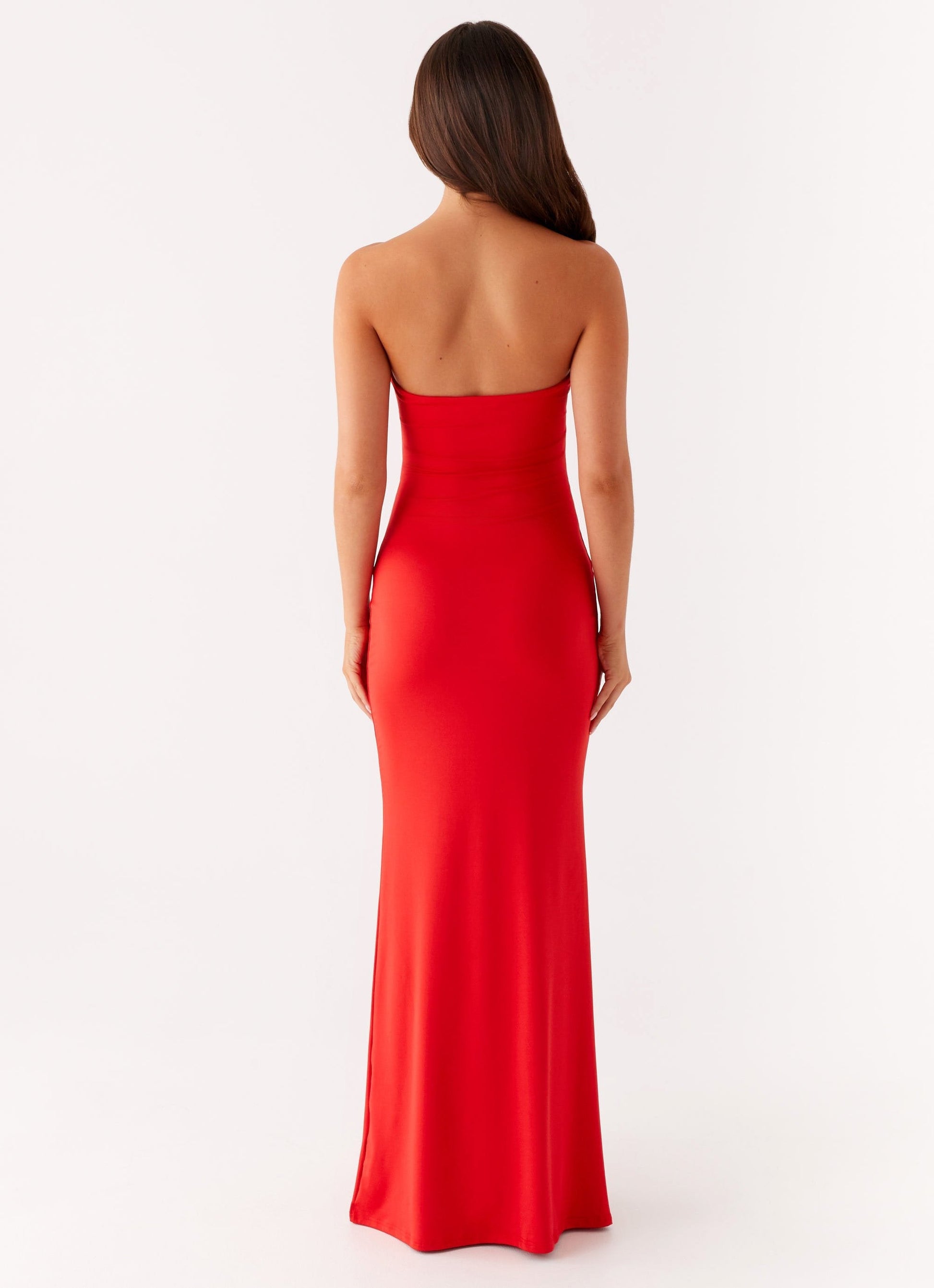 Back view of the red Vienna Cutout Maxi Dress, highlighting the strapless design and long skirt.