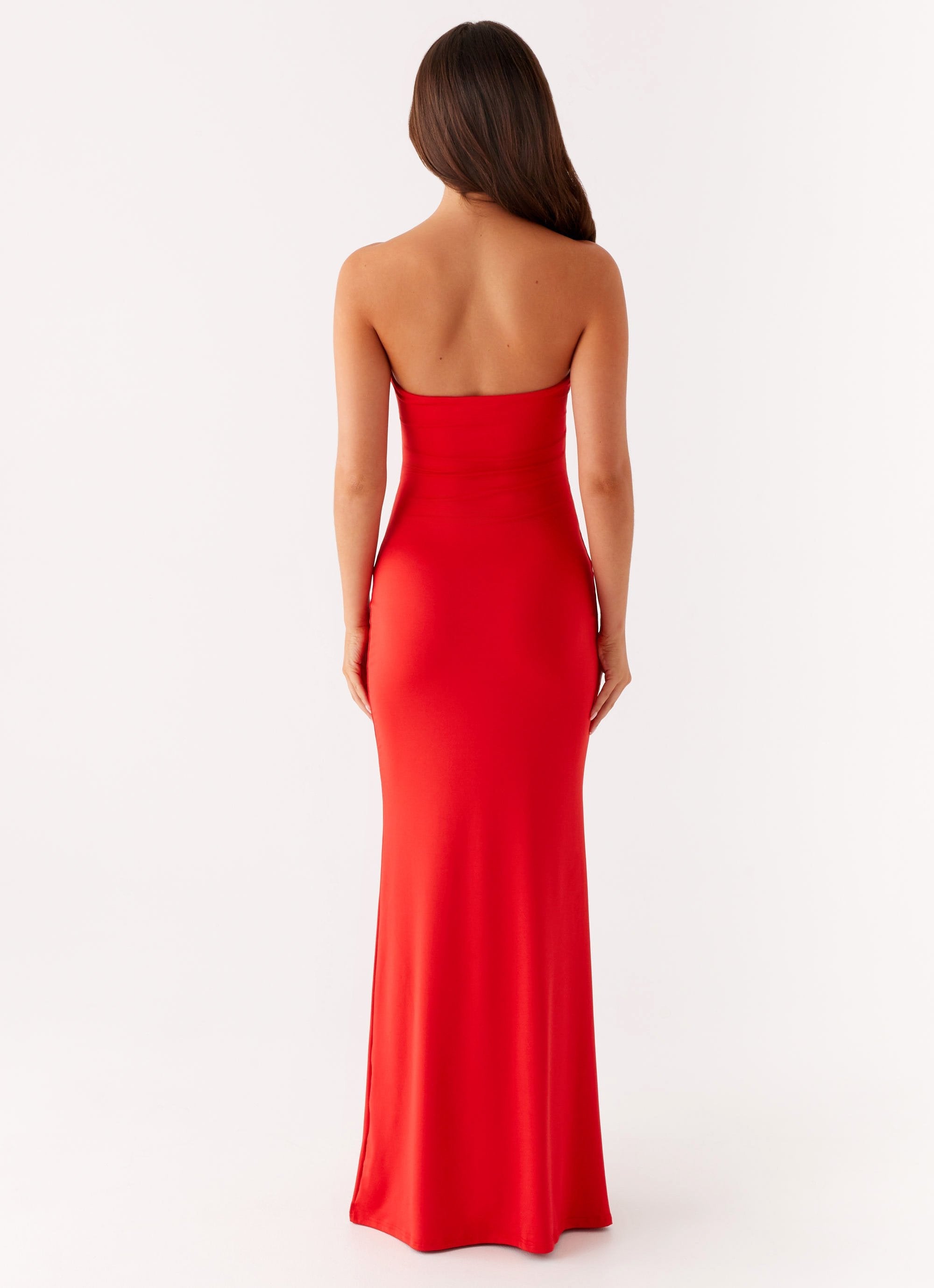 Back view of the red Vienna Cutout Maxi Dress, highlighting the strapless design and long skirt.