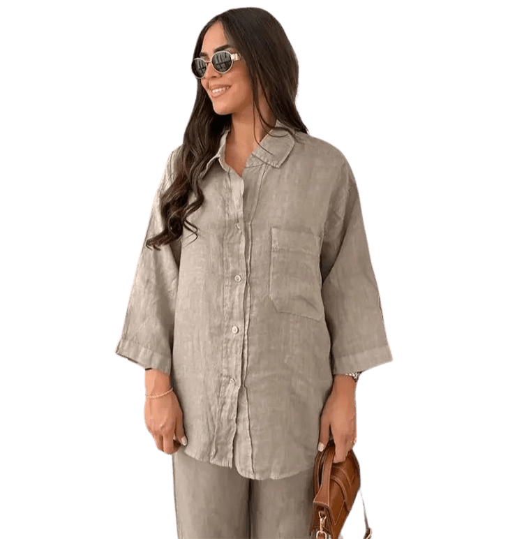 Viviana two-piece linen set in light brown, featuring a collared button-down shirt with a front pocket and matching pants, styled with sunglasses and a brown handbag.