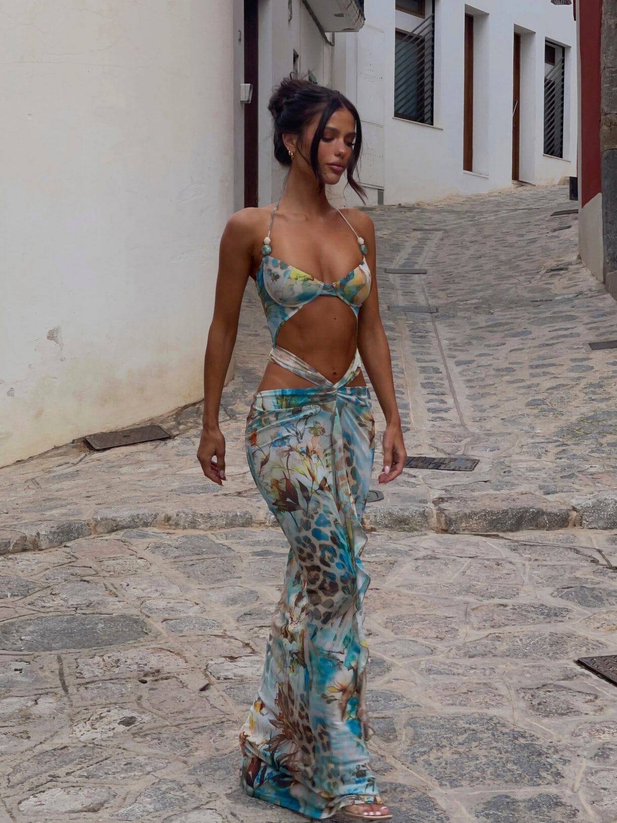 Full body view of the Vivienne Cutout Maxi Dress, showing the flowing skirt with blue, green, and brown floral print.