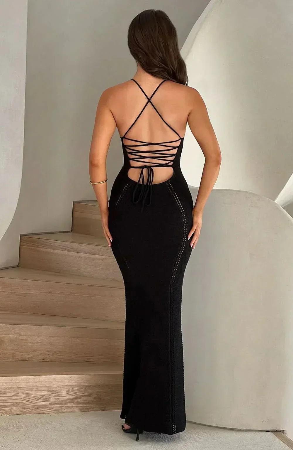 Black crochet corset maxi dress with deep V-neckline — front view highlighting waist definition
