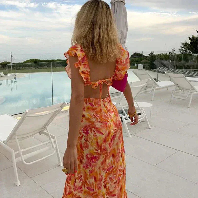 Women's floral ruffle maxi dress with V-neck, open back, and fitted summer silhouette